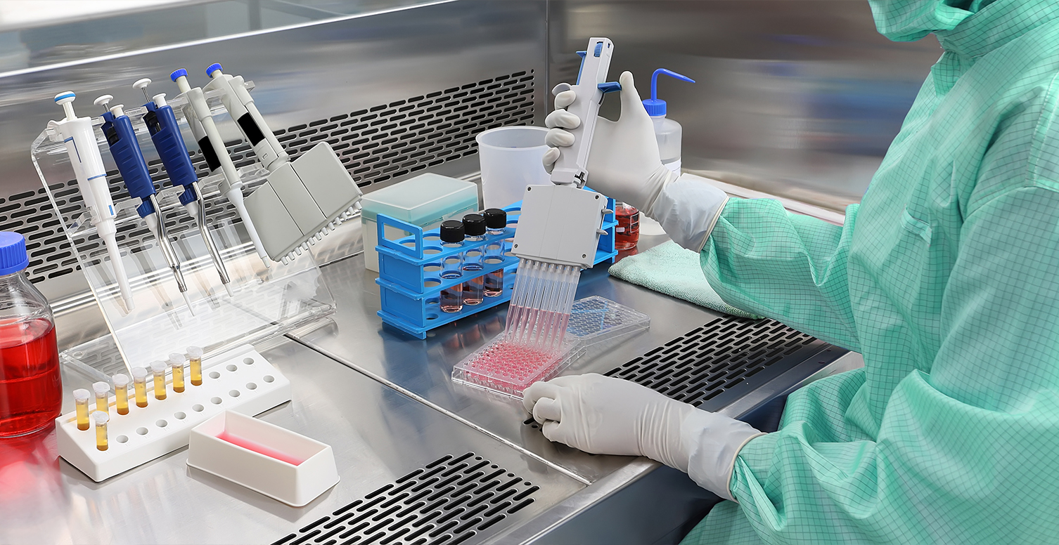 A researcher pipetting samples in a clean-room laboratory of the kind used for ancient DNA and pathogen work.